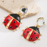 Unique red crystal ladybug earrings with niche design