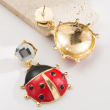 Unique red crystal ladybug earrings with niche design