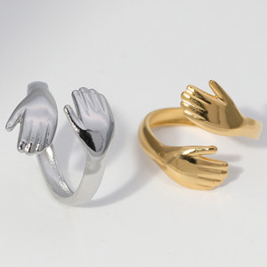 Open stainless steel  ring, woman embraces palm