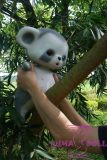 Realistic cartoon raccoon doll beside a tree