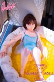 Silicone doll relaxing by water