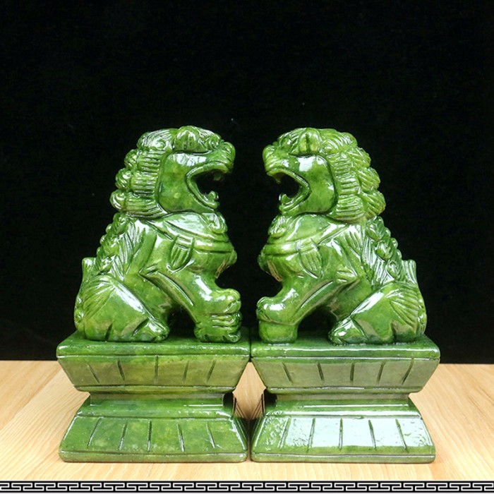 Hand-carved green jade animal carvings, green jade crystal lion climbing, and home decoration