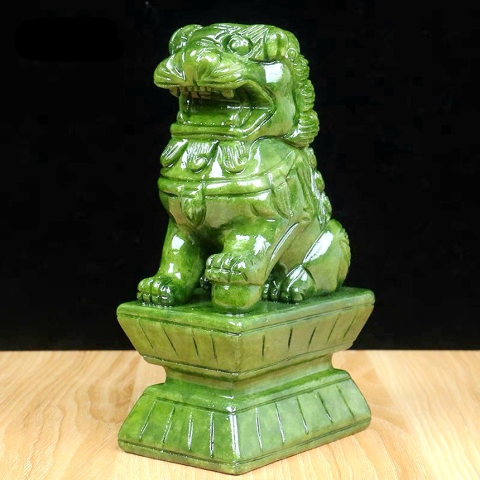 Hand-carved green jade animal carvings, green jade crystal lion climbing, and home decoration
