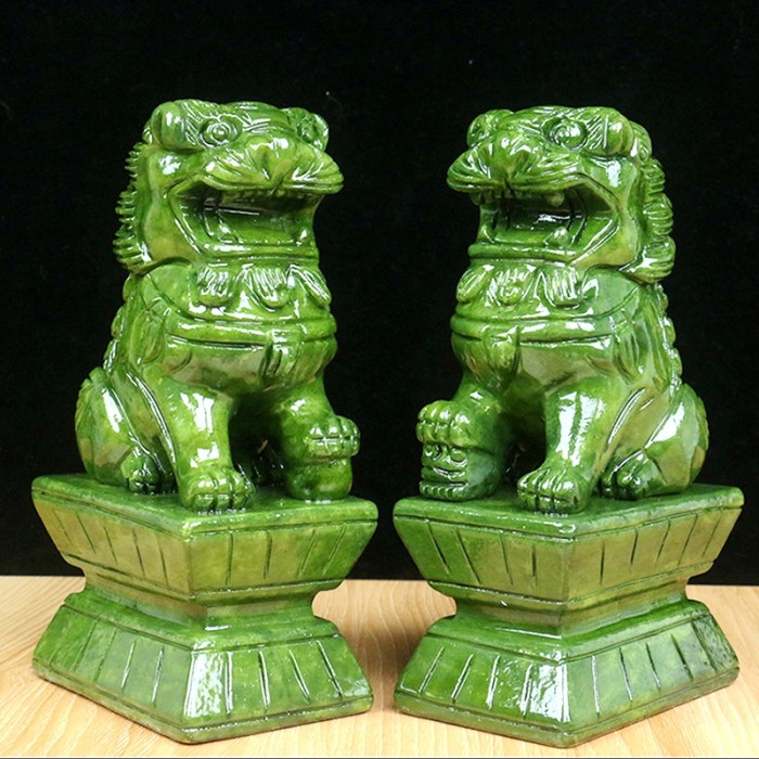 Hand-carved green jade animal carvings, green jade crystal lion climbing, and home decoration