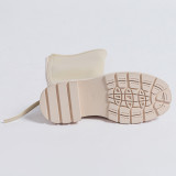 Small white boots with thick soles and high shafts are thinner than knees