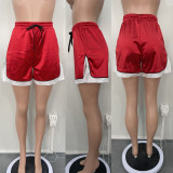 Spliced elastic bright split sports shorts