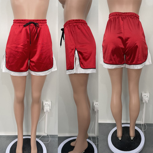 Spliced elastic bright split sports shorts