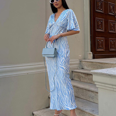 Short sleeved satin drape creates a slimming, backless style printed long dress