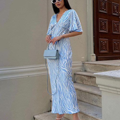 Short sleeved satin drape creates a slimming, backless style printed long dress