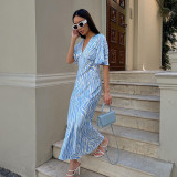 Short sleeved satin drape creates a slimming, backless style printed long dress