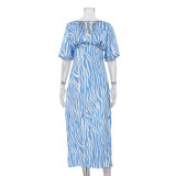 Short sleeved satin drape creates a slimming, backless style printed long dress