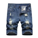 Perforated men's denim pants with many tattered jeans