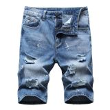 Perforated men's denim pants with many tattered jeans