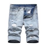 Perforated men's denim pants with many tattered jeans