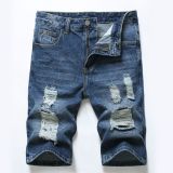 Perforated men's denim pants with many tattered jeans