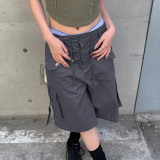 Workwear style with multiple pockets, cuffed and tied up half length pants, loose and casual low waisted straight woven shorts