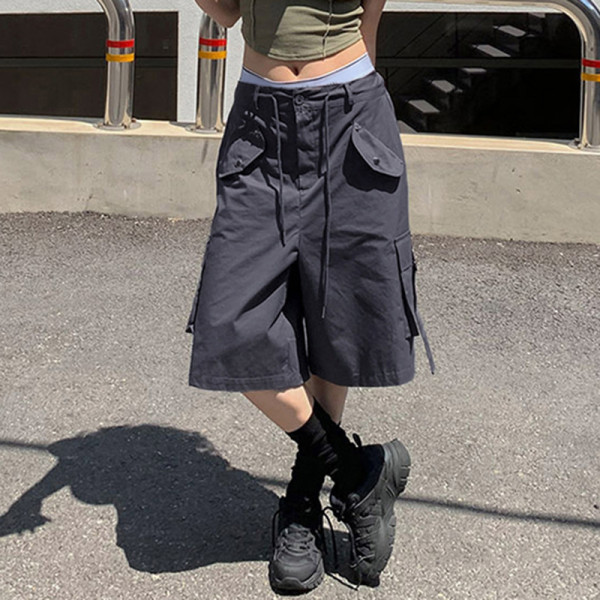 Workwear style with multiple pockets, cuffed and tied up half length pants, loose and casual low waisted straight woven shorts