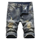 Perforated men's denim pants with many tattered jeans