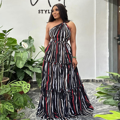 Printed patchwork with straps, large skirt hem, sloping shoulder, backless dress