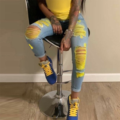 Light colored perforated elastic jeans