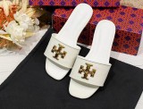 A pair of sheepskin slippers with a simple flat bottom on top