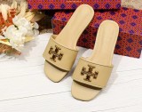 A pair of sheepskin slippers with a simple flat bottom on top
