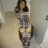 One neck chest hugging top, tight fitting cropped pants, printed suit