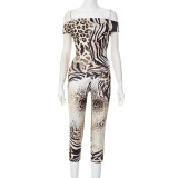 One neck chest hugging top, tight fitting cropped pants, printed suit