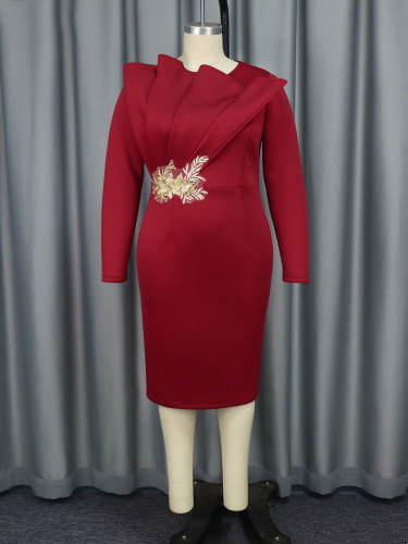 Embroidered long sleeved evening gown, mid length skirt