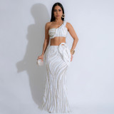 Sleeveless single shoulder short top paired with hip hugging skirt