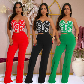 Two piece set of strapless short top paired with solid colored pants