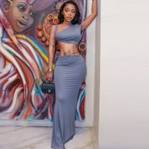 Two piece set with exposed navel, strapless sloping collar top, hip hugging long skirt