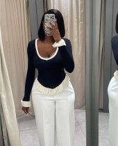 Contrast striped knit shirt with ruffled hem and flared sleeves as a base top