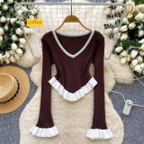 Contrast striped knit shirt with ruffled hem and flared sleeves as a base top