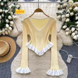 Contrast striped knit shirt with ruffled hem and flared sleeves as a base top