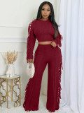 Solid color knitted long sleeved tassel set