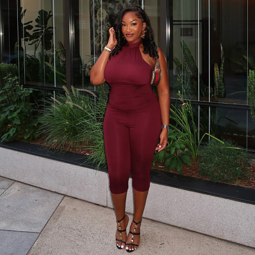 Hanging neck strap backless solid color pleated waist cinching seven part jumpsuit