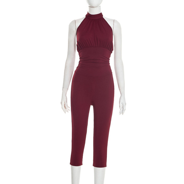 Hanging neck strap backless solid color pleated waist cinching seven part jumpsuit
