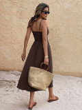 A solid color backless dress with a single neckline camisole and a long skirt