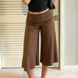 Low waisted, flared, and loose mid length pants with a hanging feel