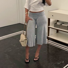 Low waisted, flared, and loose mid length pants with a hanging feel
