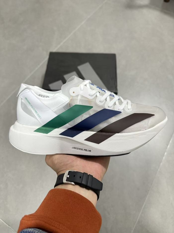 AD x Pharrell Williams  Adizero Adios Pro Evo 1  Earth  LightStrike Pro Transparent Tulle Mesh Marathon Running Sneakers 29336030